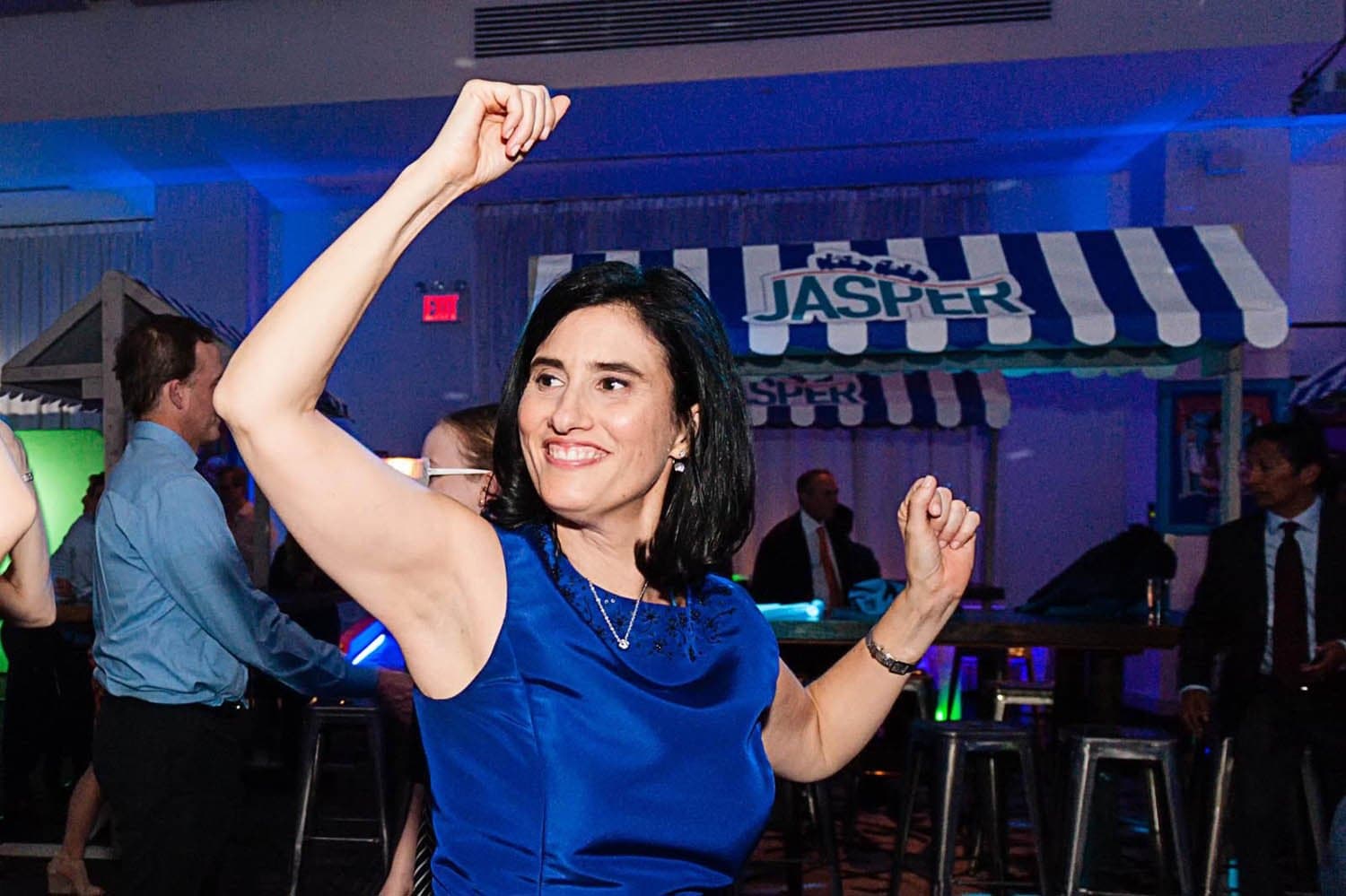 Woman in a blue dress dancing at a mitzvah party