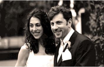 Black-and-white portrait of a smiling bride and groom